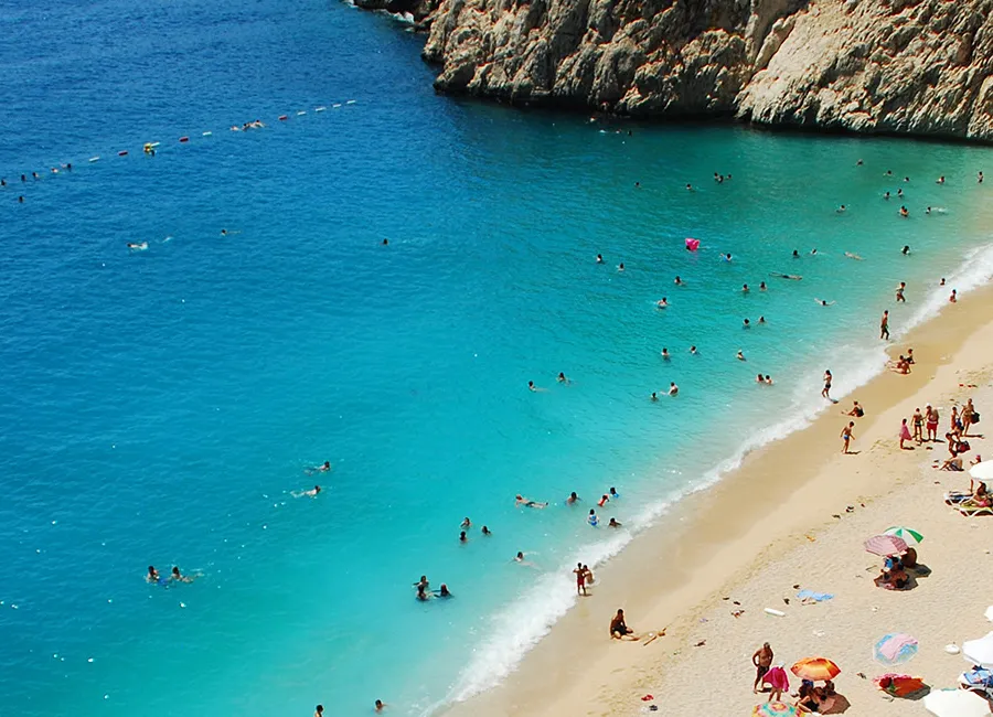 Aerial view of Kaputaş Beach's turquoise cove between steep cliffs
